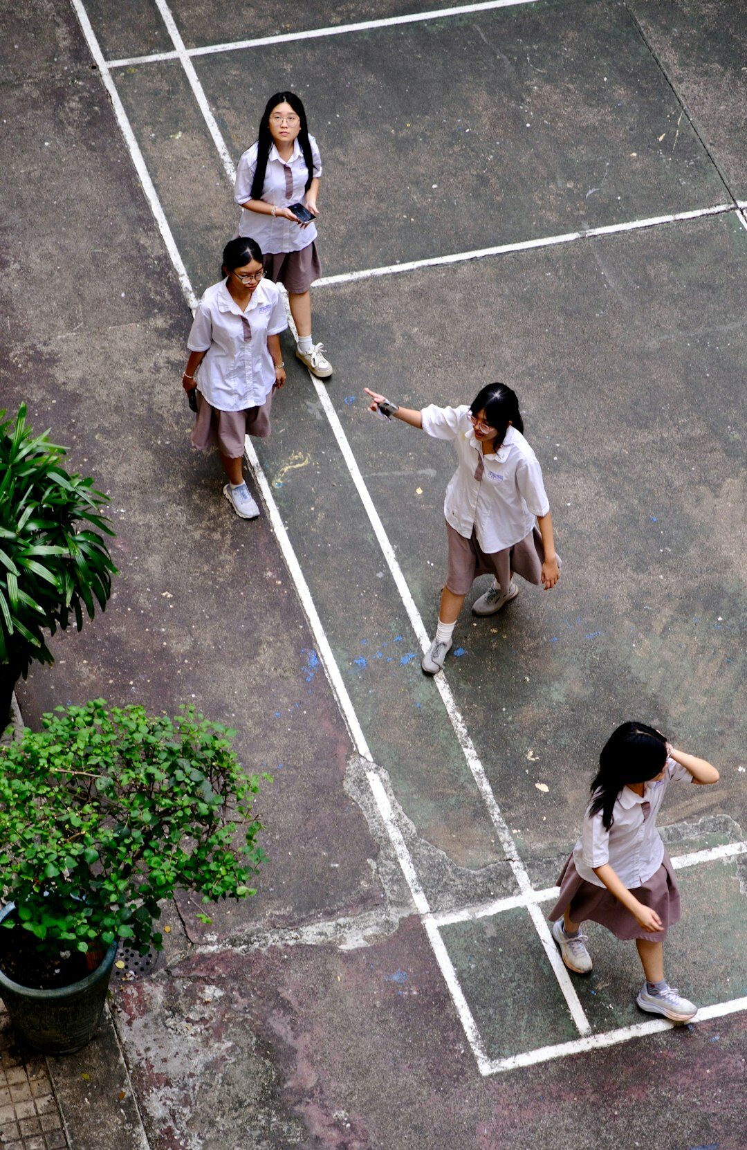 teens discussing in schoolyard
